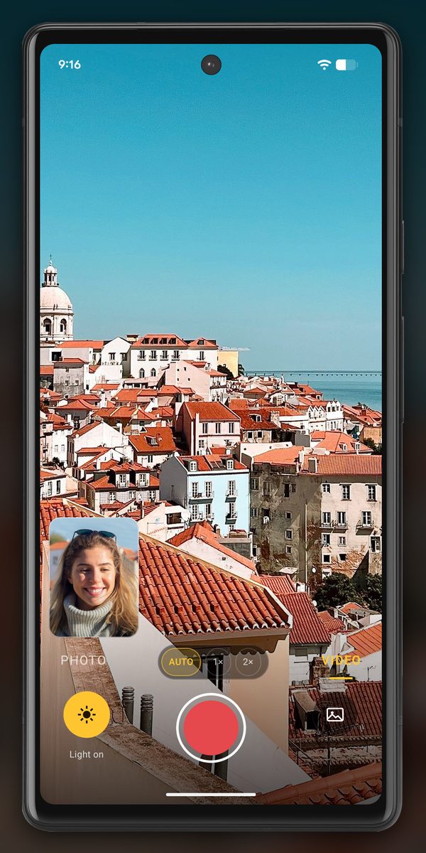 InspectCam’s Dual screen in VIDEO on an Android phone: the back camera shows Lisbon’s red rooftops and the sea, and a small front-camera window at the bottom left shows a smiling tourist.