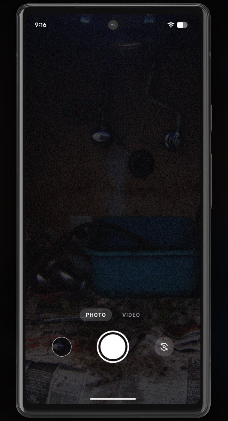 A phone under a sink with a plain camera app open: the pipes, valves and a plastic tub are barely visible in a dark, grainy picture, with Photo and Video and a white shutter button at the bottom.