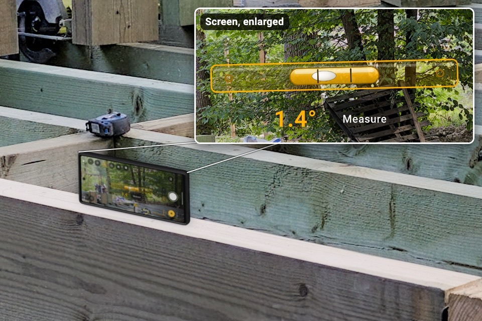 A phone on its long side on a rim joist, reading 1.4 degrees, with an inset of its screen.
